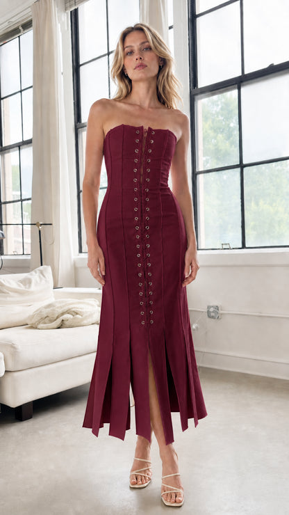 Model wearing burgundy strapless lace-up midi dress