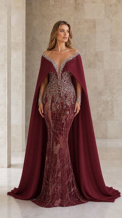 Front view of burgundy red beaded evening gown with dramatic cape