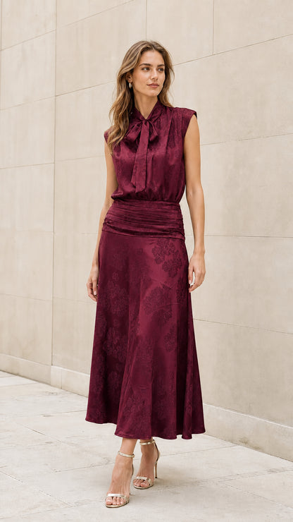 Front view of model wearing burgundy tie-neck midi dress