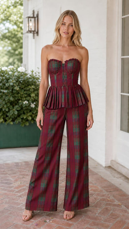 Model wearing burgundy multi plaid strapless corset peplum top and wide leg pants set