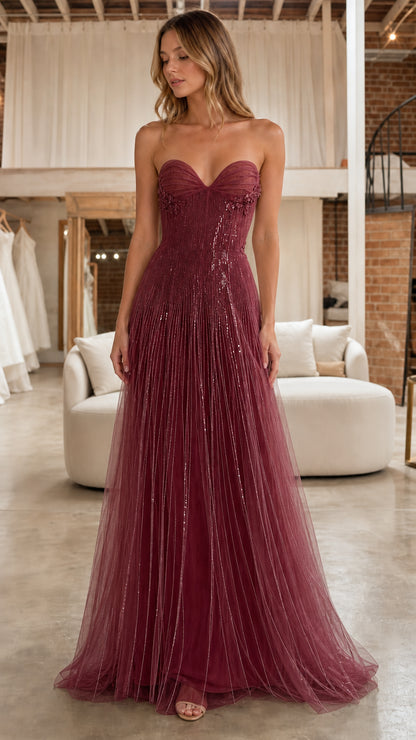 Front full view of model in the burgundy strapless beaded tulle evening gown