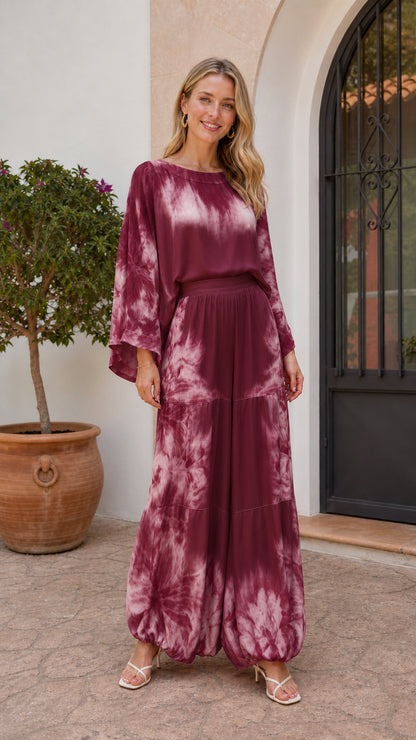 Model wearing burgundy tie-dye two-piece set