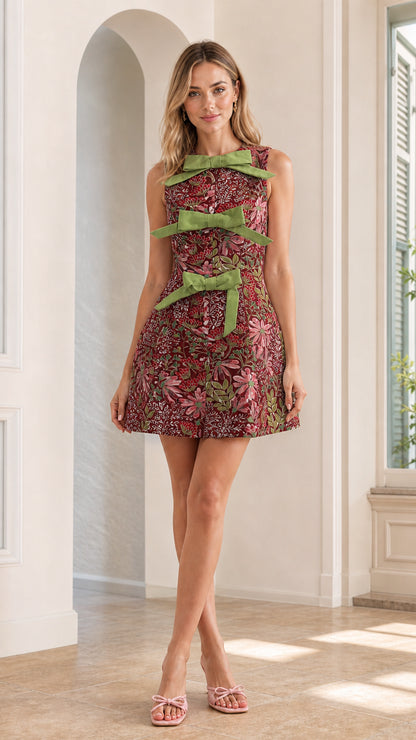 Front full view of burgundy multi floral bow mini dress