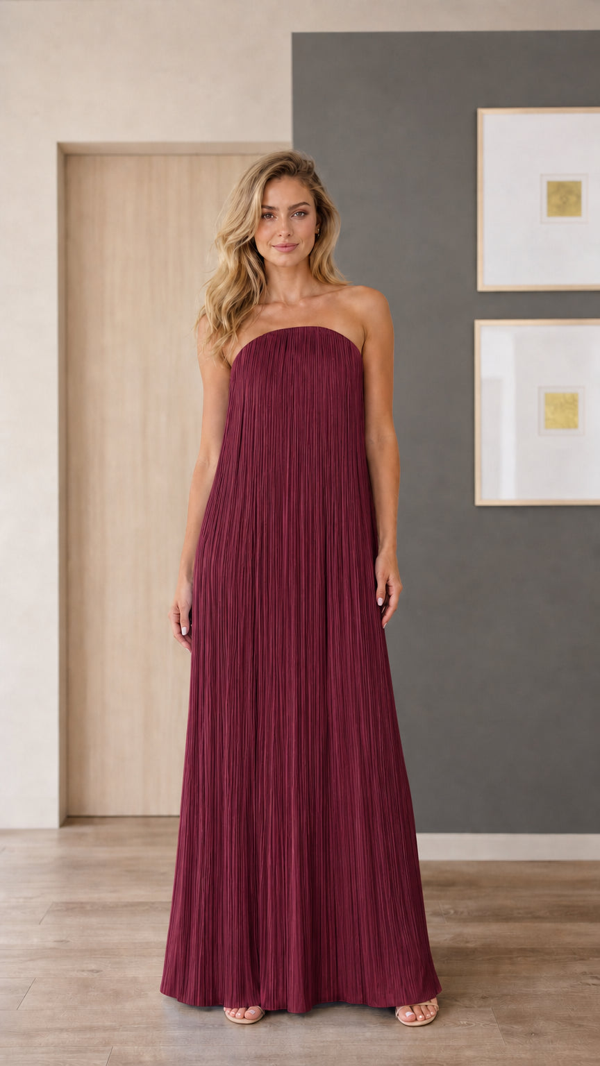 Model wearing burgundy strapless pleated maxi dress