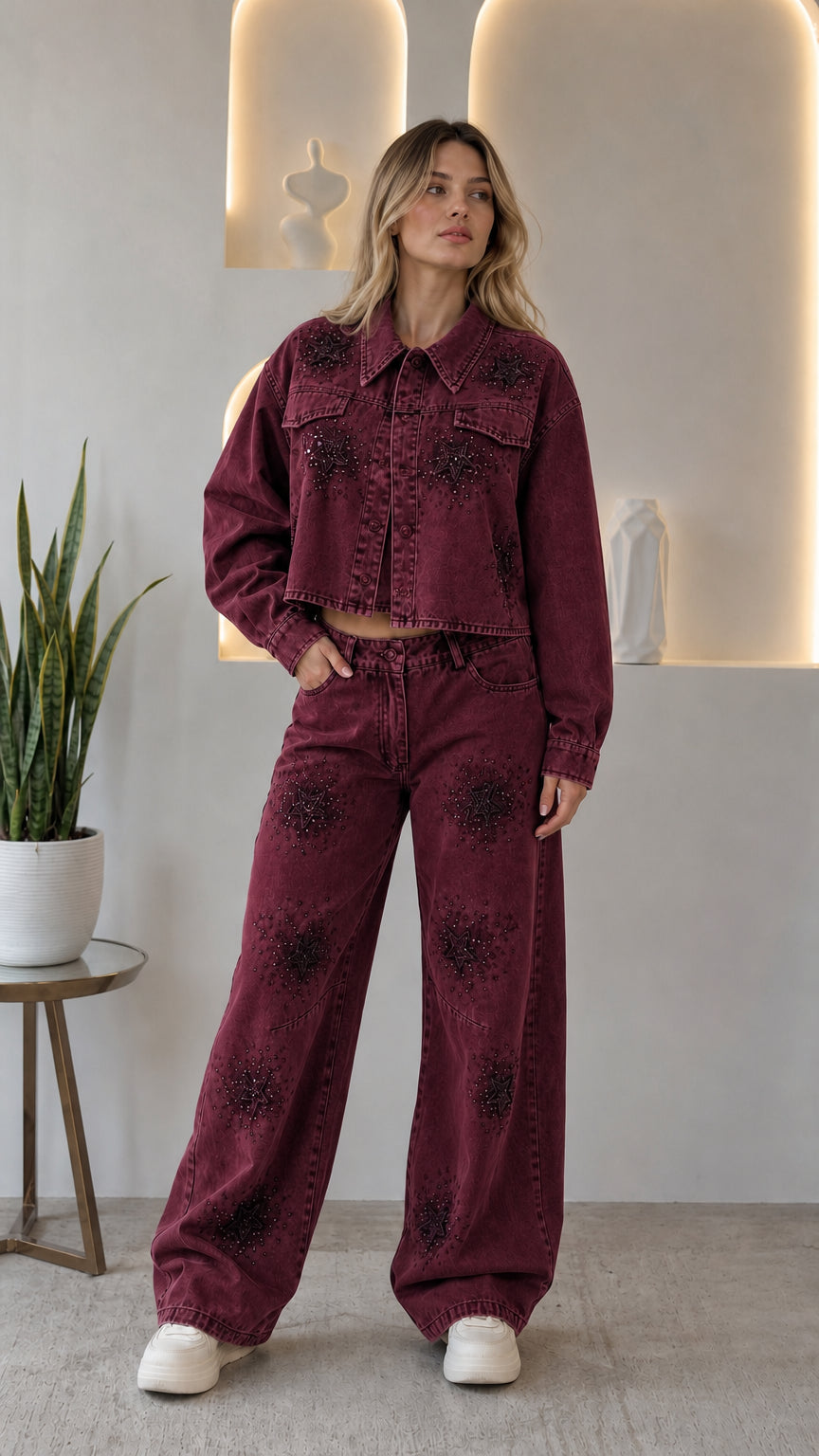 Woman wearing burgundy wine rhinestone star cropped denim jacket and wide leg jeans two-piece set