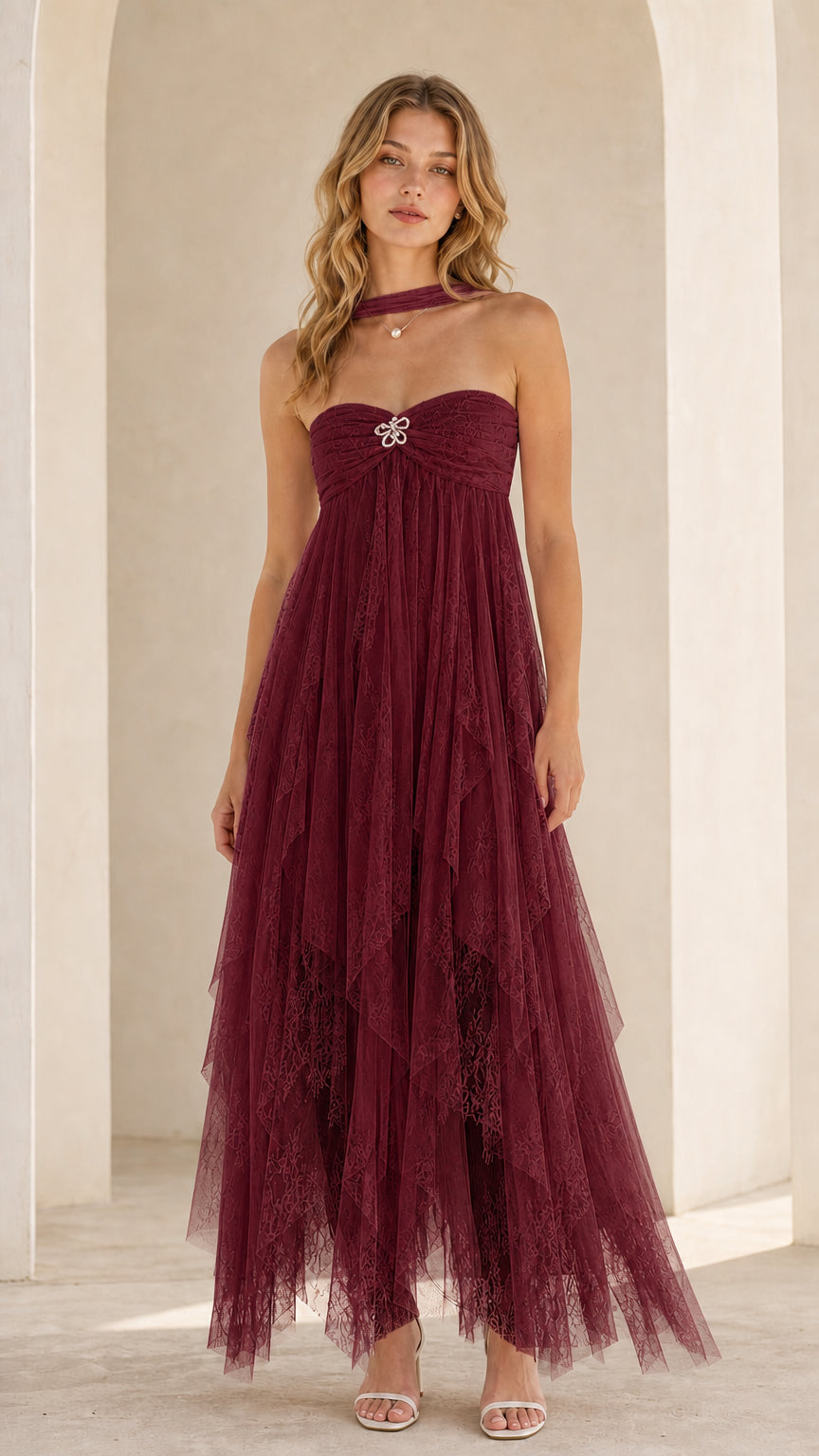Model wearing burgundy strapless tulle maxi dress