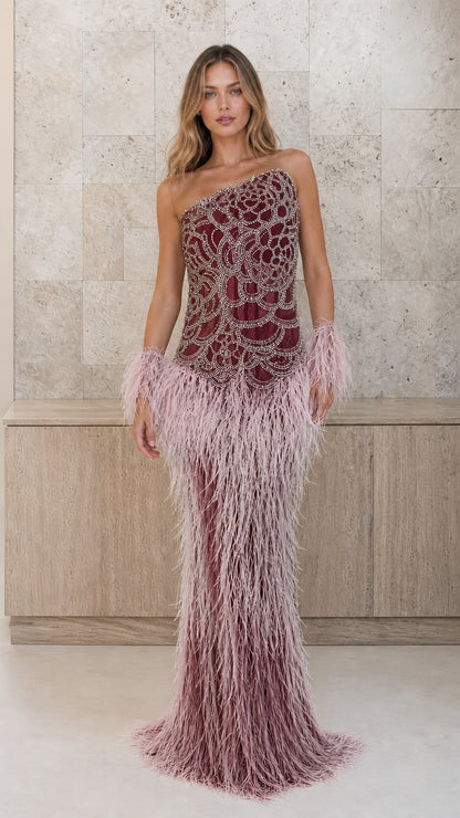 Burgundy beaded one-shoulder gown with ombre feather skirt and cuffs