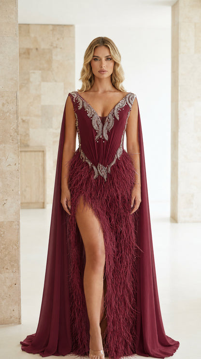 Burgundy red formal cape gown with crystal-beaded bodice and feather trim