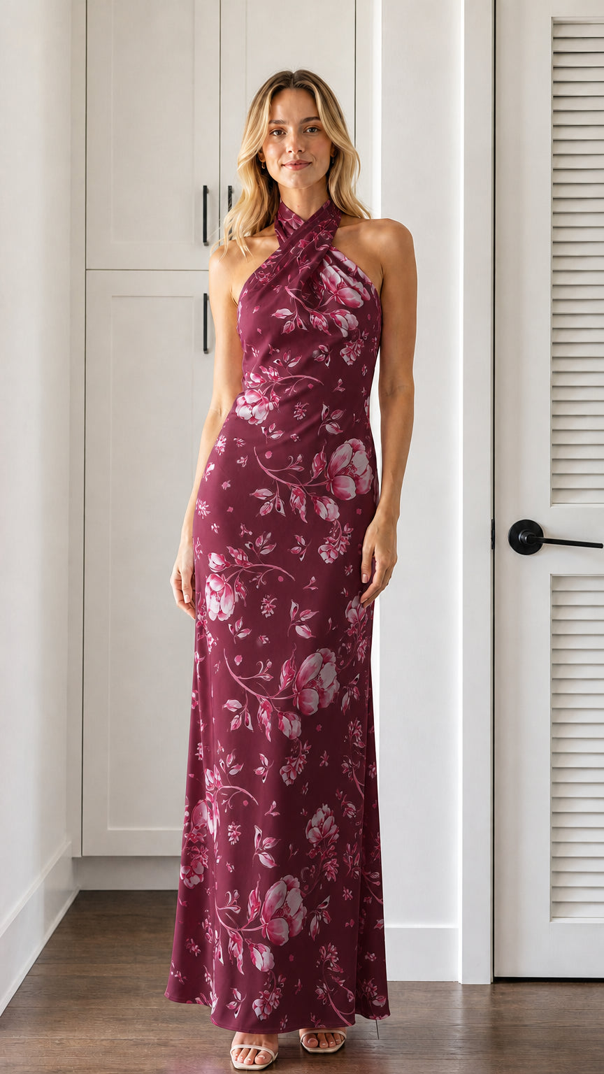 Front view of model wearing burgundy floral halter neck maxi dress