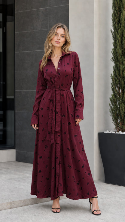 Front view of woman wearing burgundy floral long-sleeve maxi dress