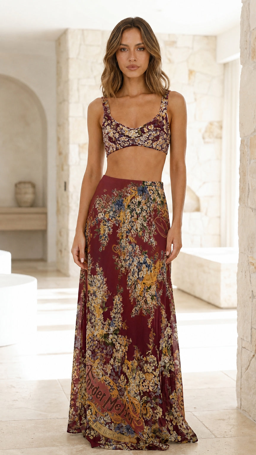 Model wearing burgundy floral crop top and maxi skirt set
