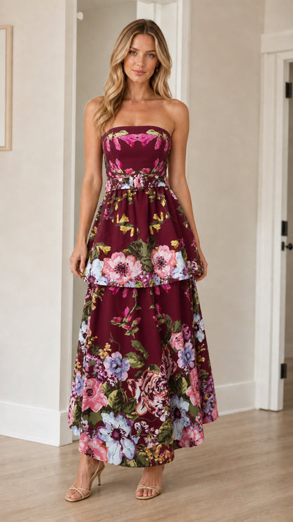 Woman wearing burgundy floral strapless tiered maxi dress