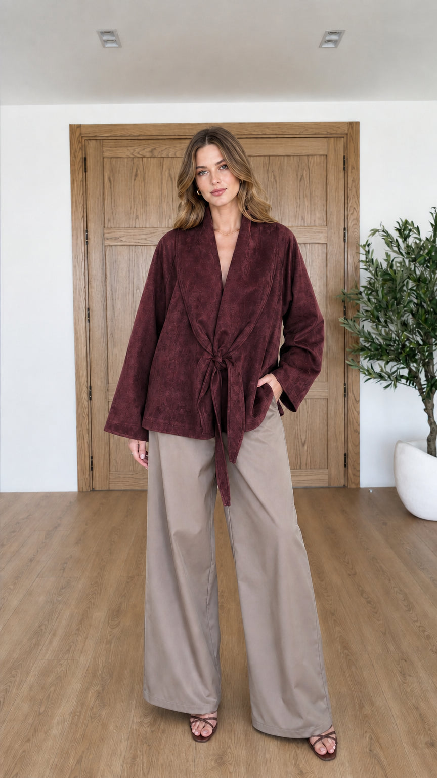 Front view of woman wearing Burgundy faux suede tie-front wrap jacket