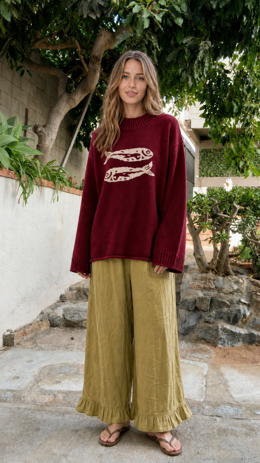 Front view of model wearing Burgundy deep red fish graphic knit sweater