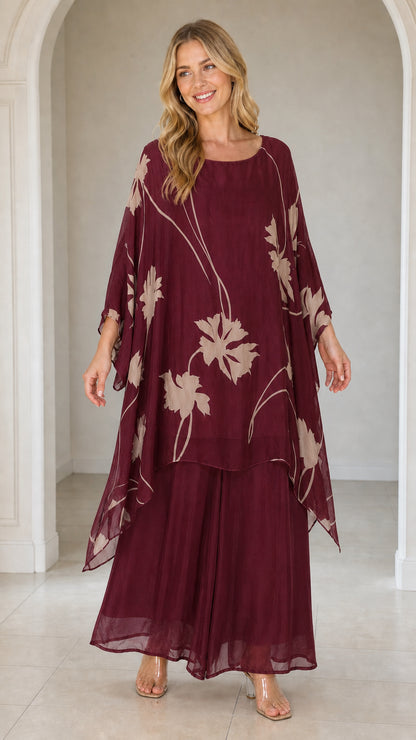 Front view of woman wearing burgundy floral kaftan set