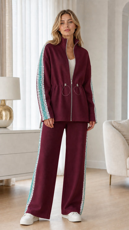 Full-length view of woman wearing burgundy two-piece track set with sequin trim