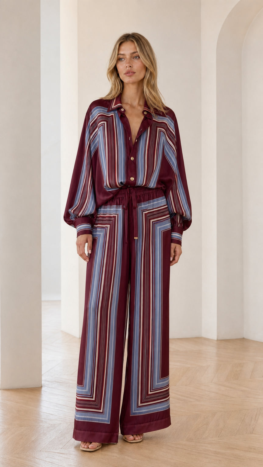 Model wearing burgundy geometric striped two-piece set