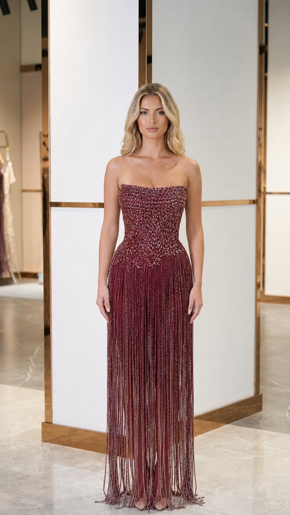 Model wearing burgundy color variant of crystal fringe evening gown