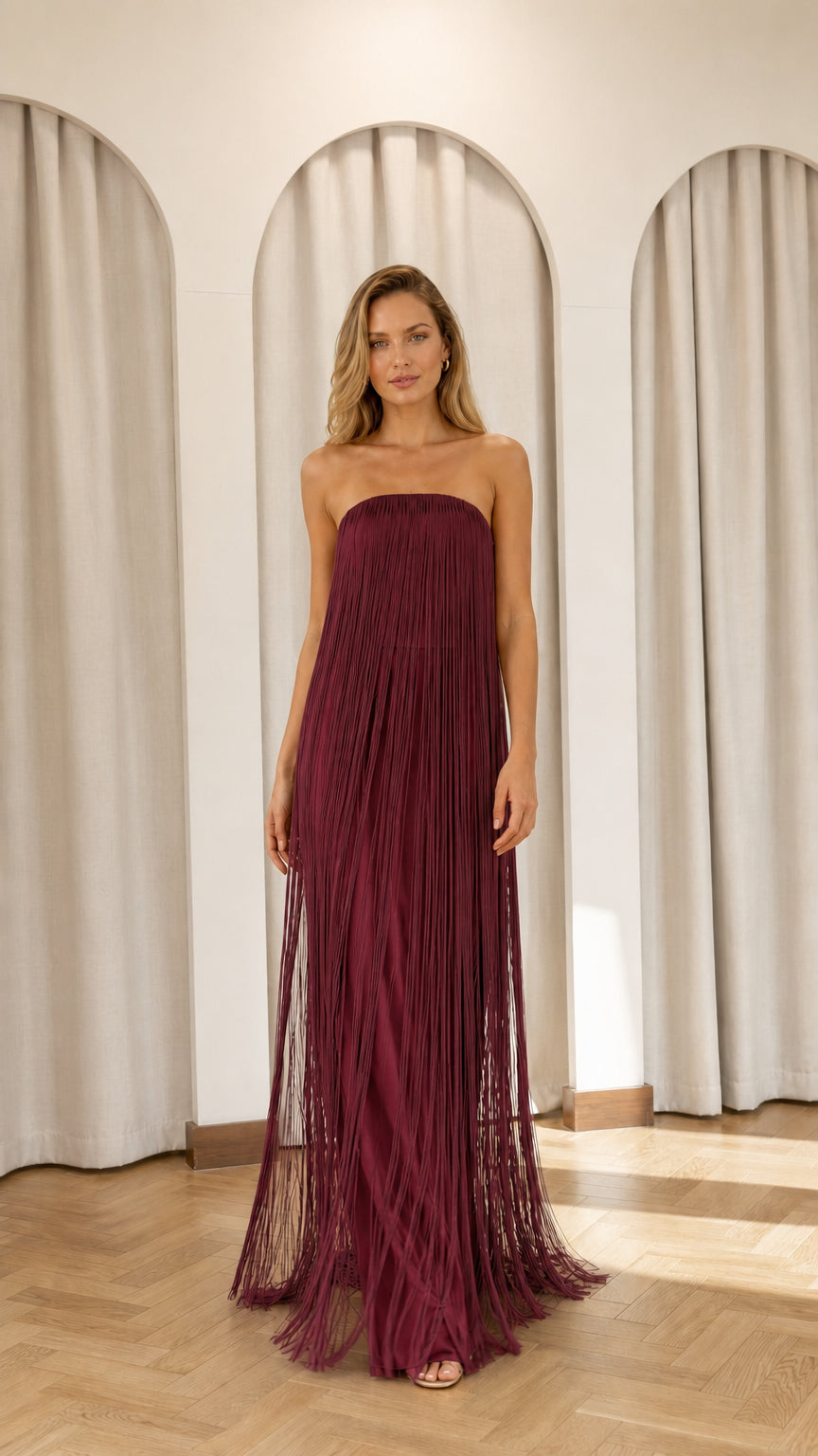 Full view of model wearing burgundy strapless fringe maxi dress
