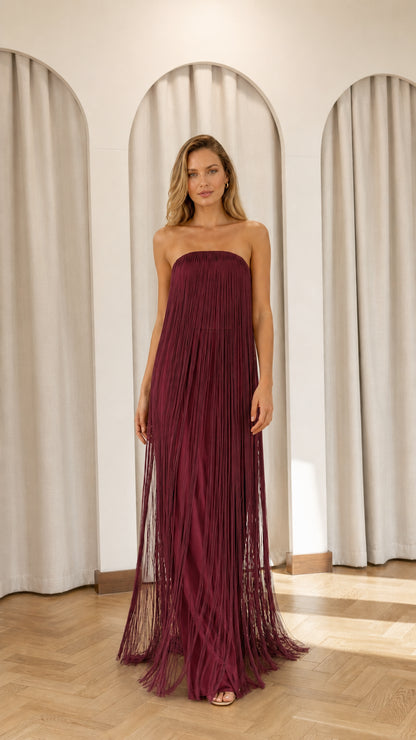 Full view of model wearing burgundy strapless fringe maxi dress