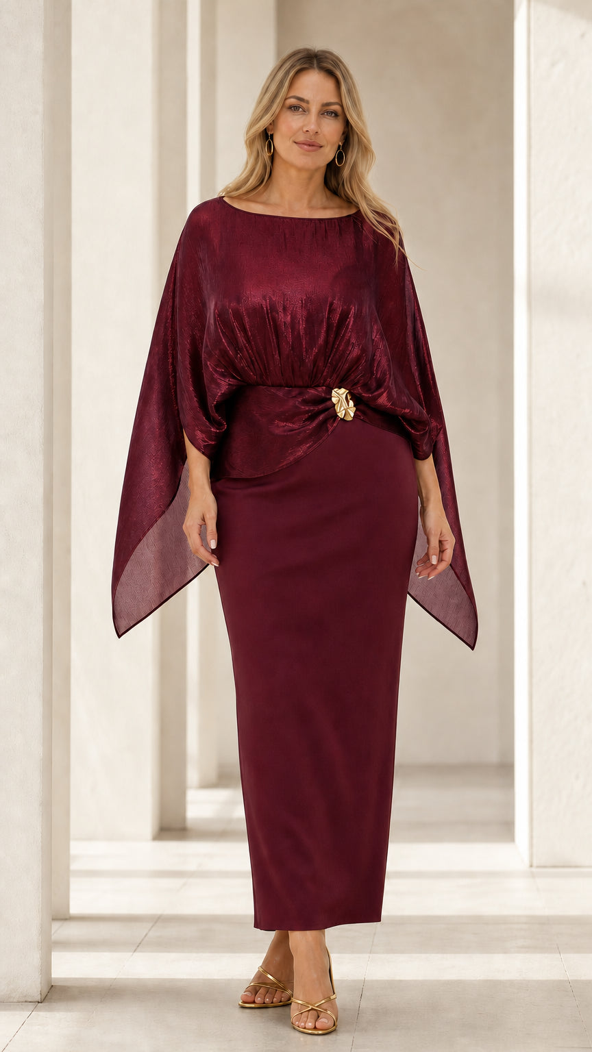 Front view of woman wearing burgundy wine metallic drape capelet maxi gown