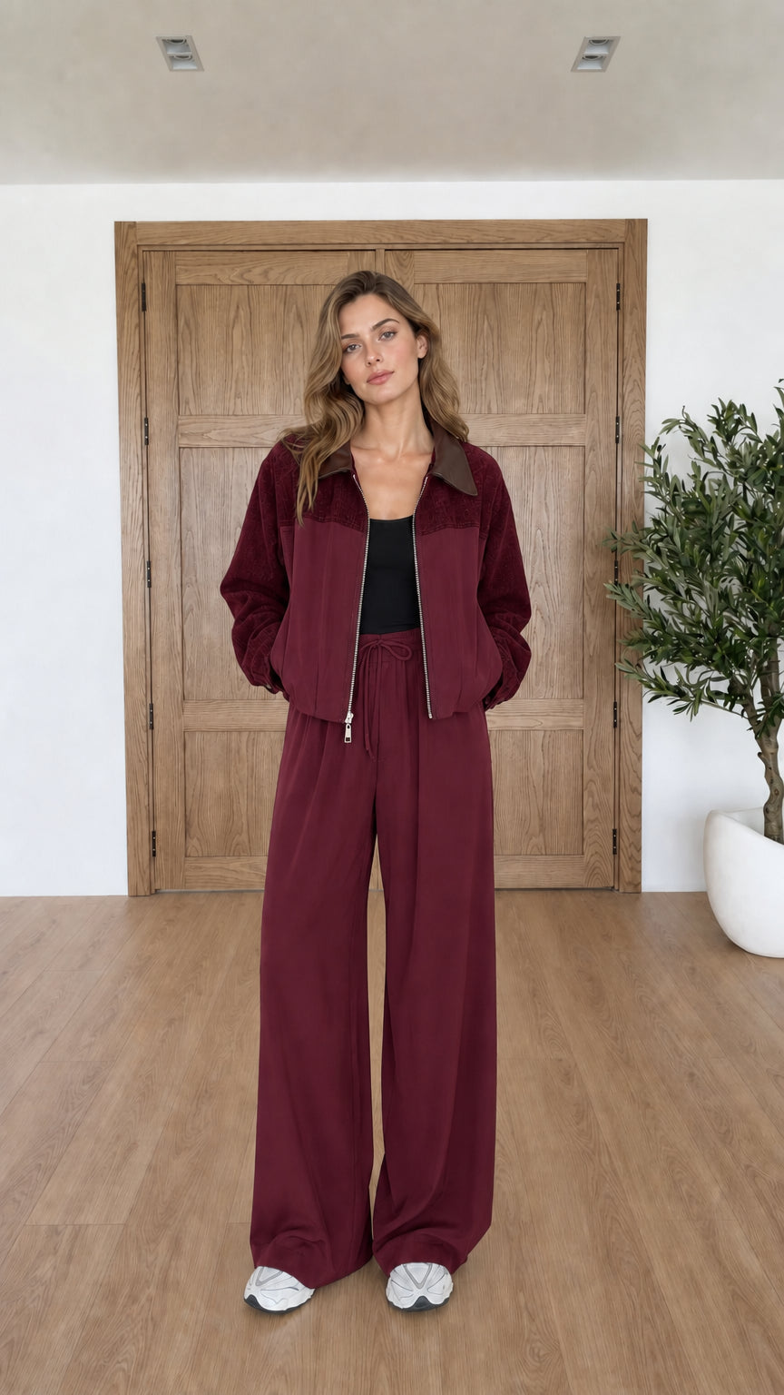 Model wearing burgundy wine two-piece jacket and wide leg pants set