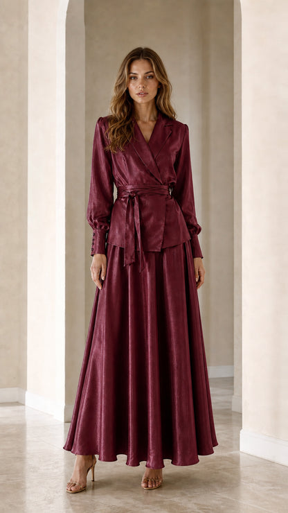 Front full view of woman wearing Burgundy wine red satin wrap blazer and maxi skirt two-piece set