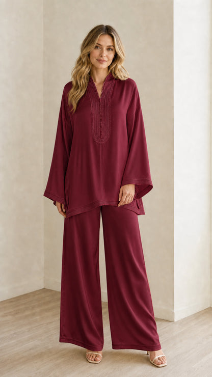 Full-length view of woman wearing the deep burgundy embroidered tunic and trouser outfit