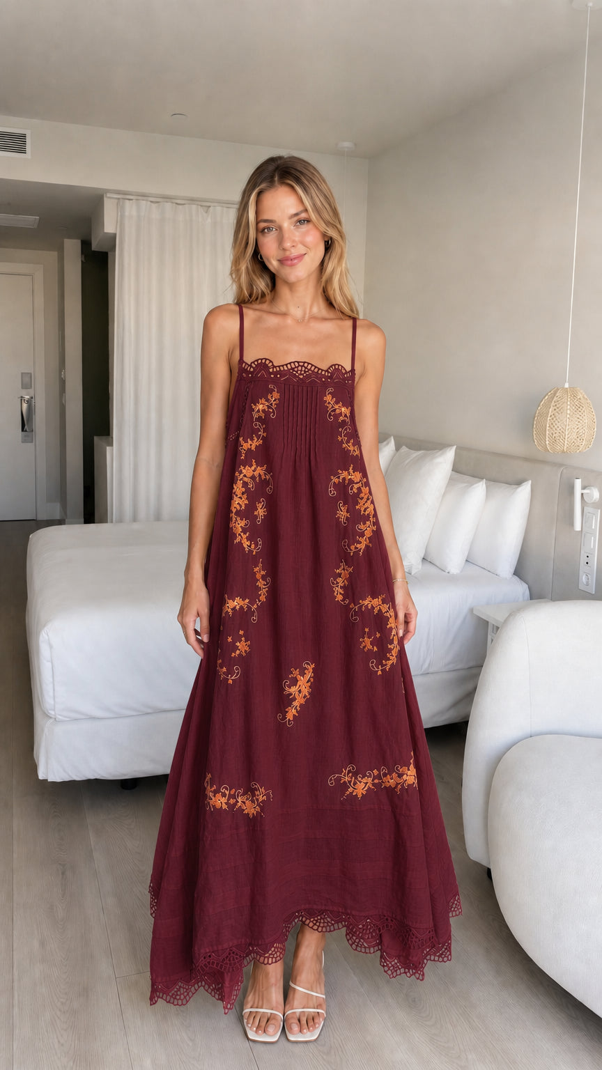 Model wearing burgundy embroidered maxi dress