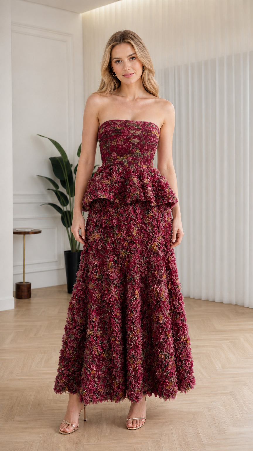 Front view of model wearing burgundy floral strapless ruffle peplum maxi dress