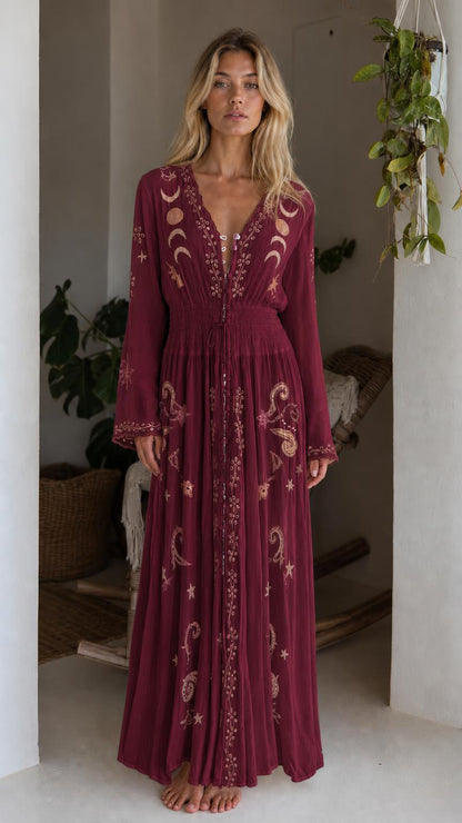 Front view of model wearing burgundy celestial embroidered maxi dress