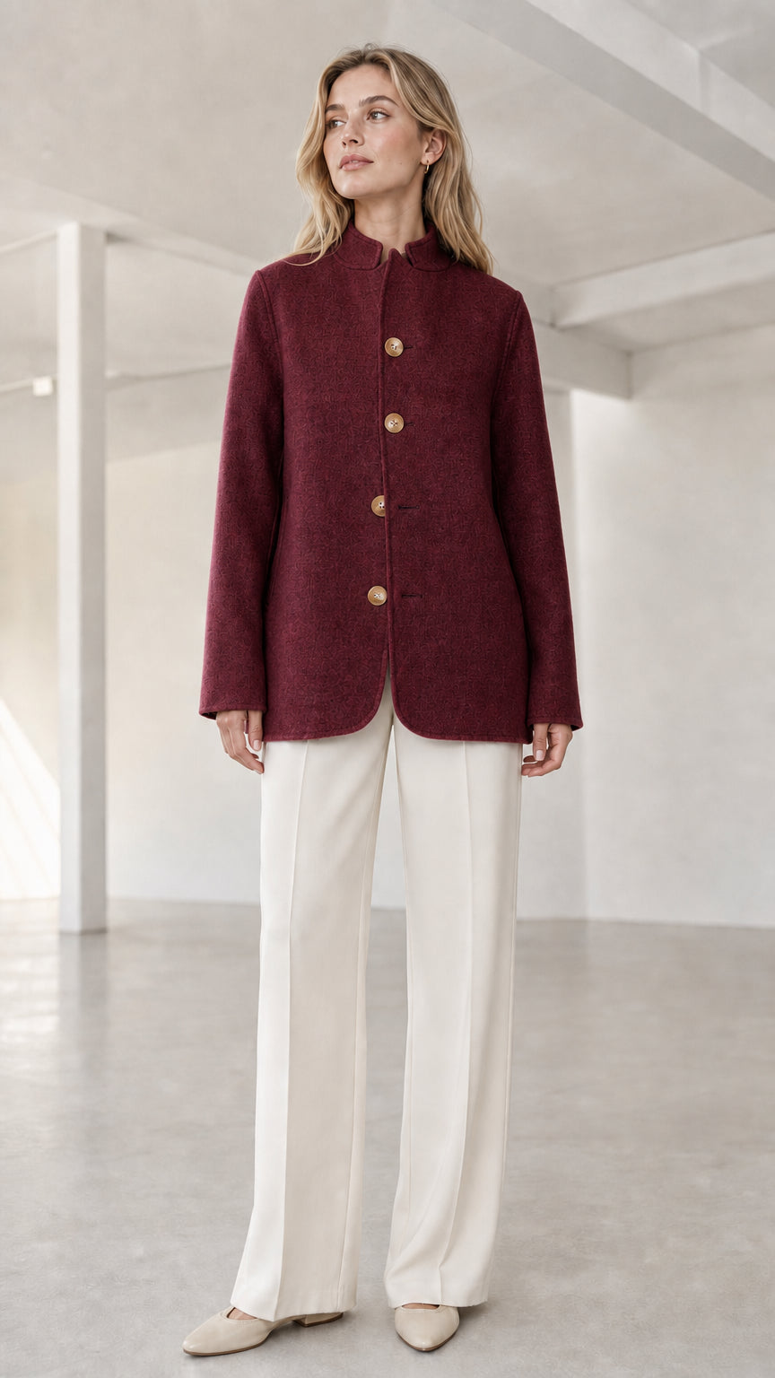 Front view of model wearing burgundy wine red stand collar button coat