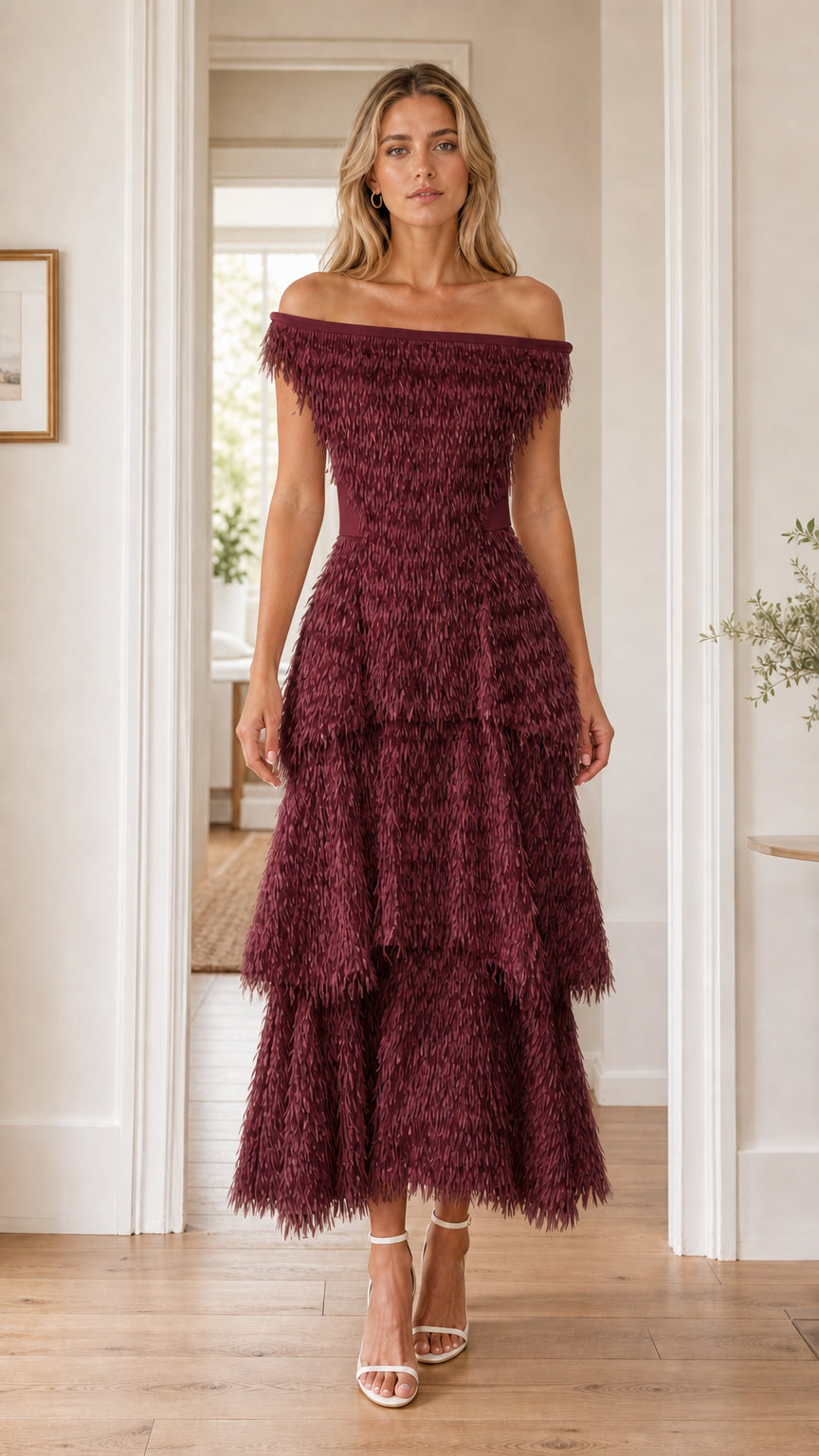 Front view of woman in burgundy off-the-shoulder fringe dress