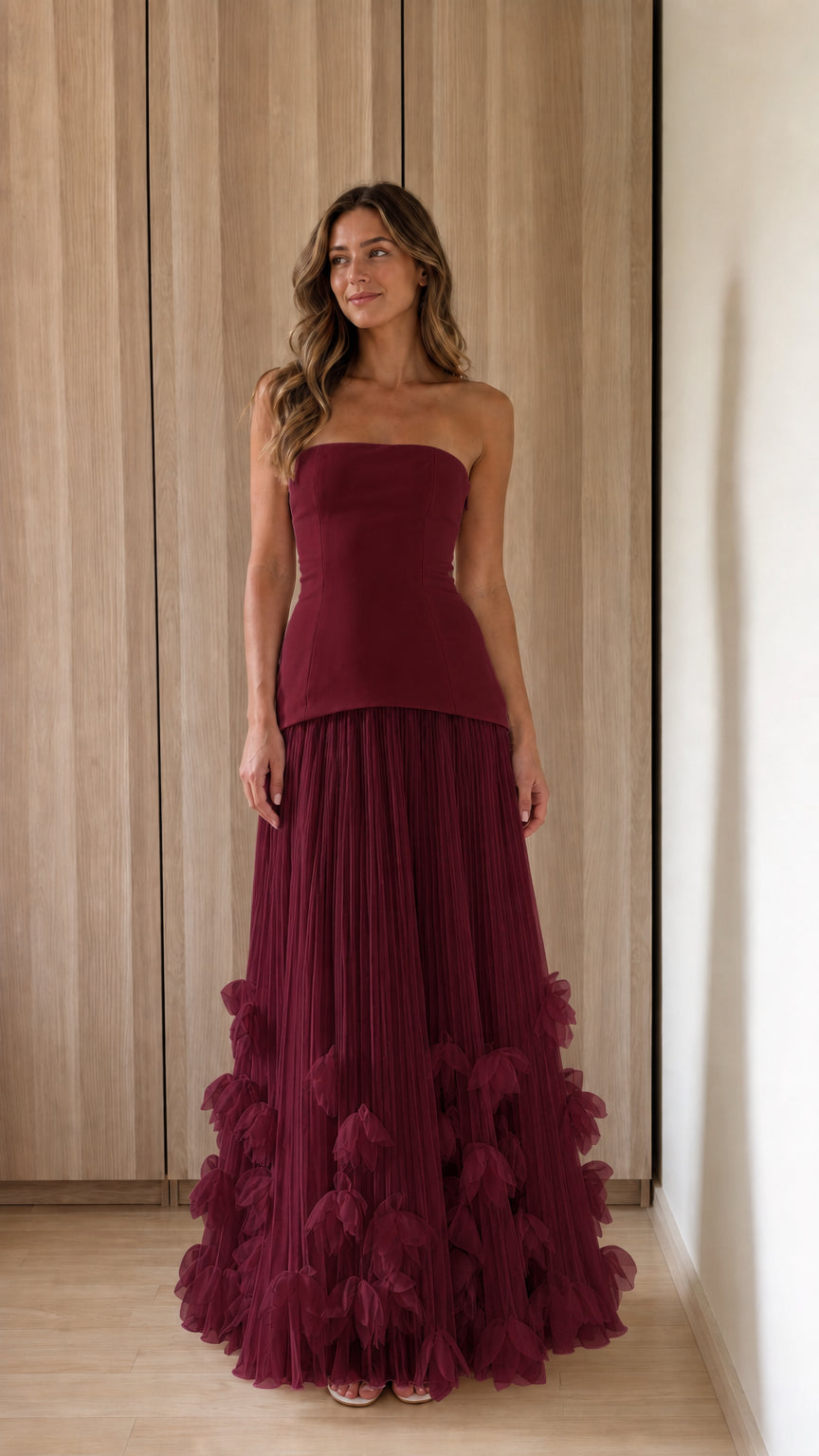 Woman wearing burgundy strapless 3d floral tulle maxi dress