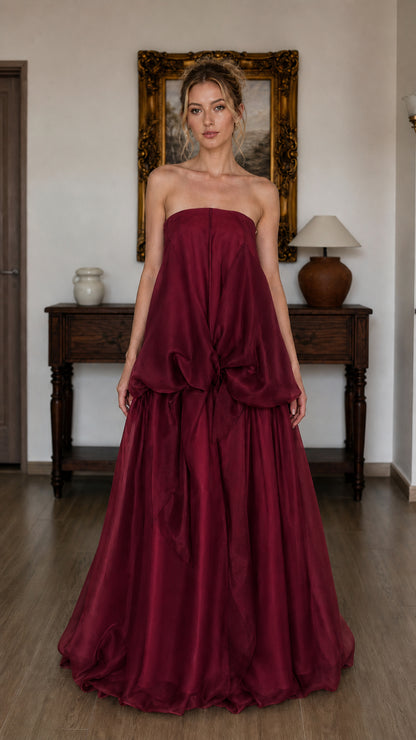 Model wearing burgundy strapless tiered maxi dress