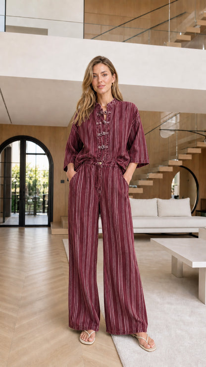 Model wearing burgundy striped matching set