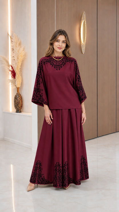 Model wearing Burgundy modest two-piece set with black scrollwork prints
