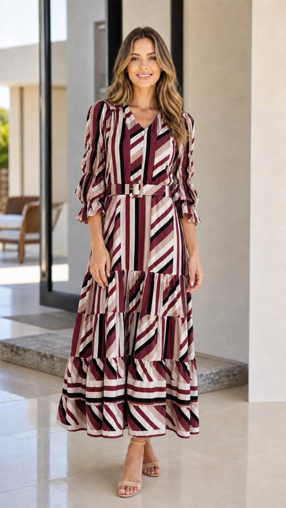 Front view of woman wearing burgundy geometric striped tiered midi dress
