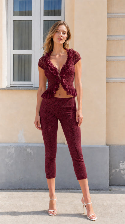Full front view of model wearing burgundy floral lace two-piece capri set