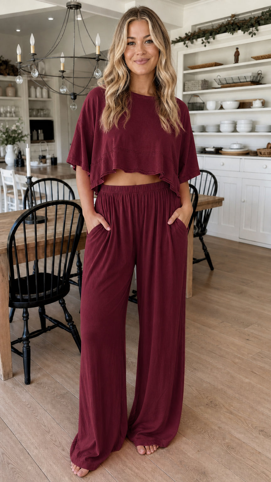 Front view of woman wearing burgundy two piece cropped top and wide leg pant set
