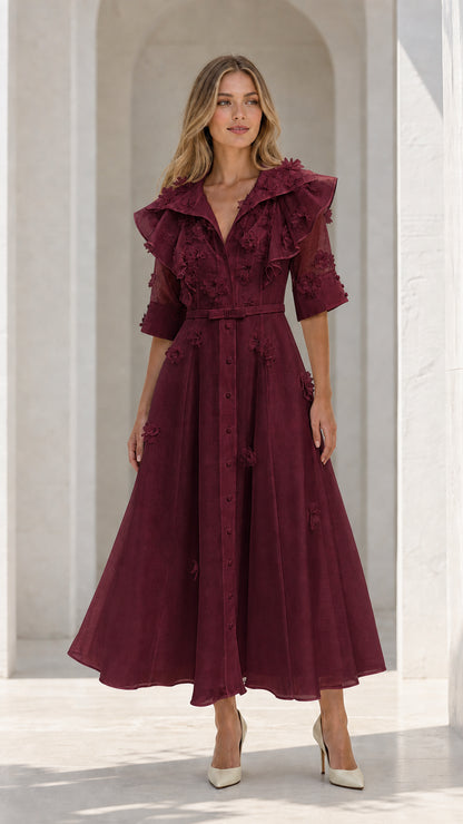 Model wearing burgundy floral applique ruffle midi dress