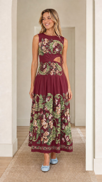Woman wearing burgundy floral print cutout maxi dress