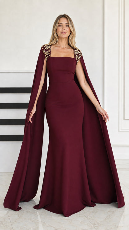 Front view of burgundy wine red cape sleeve mermaid evening gown