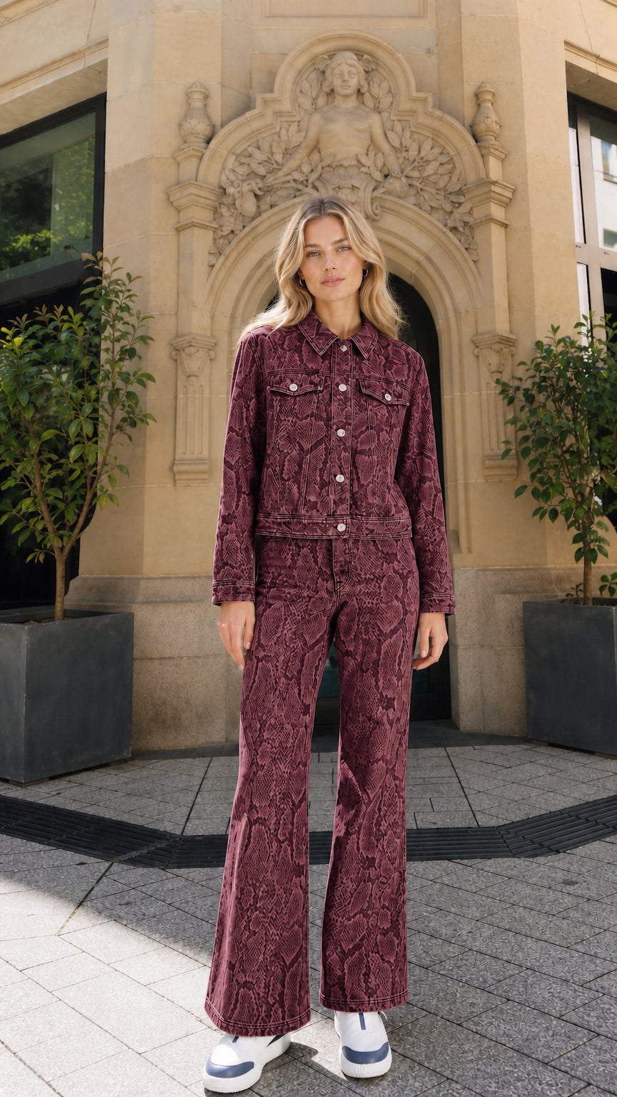 Full view of model wearing burgundy snake print denim matching set