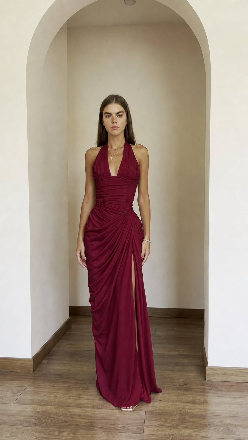 Front view of model wearing burgundy halter ruched maxi dress