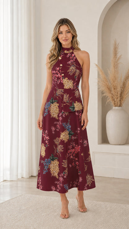 Model wearing burgundy floral print halter neck midi dress