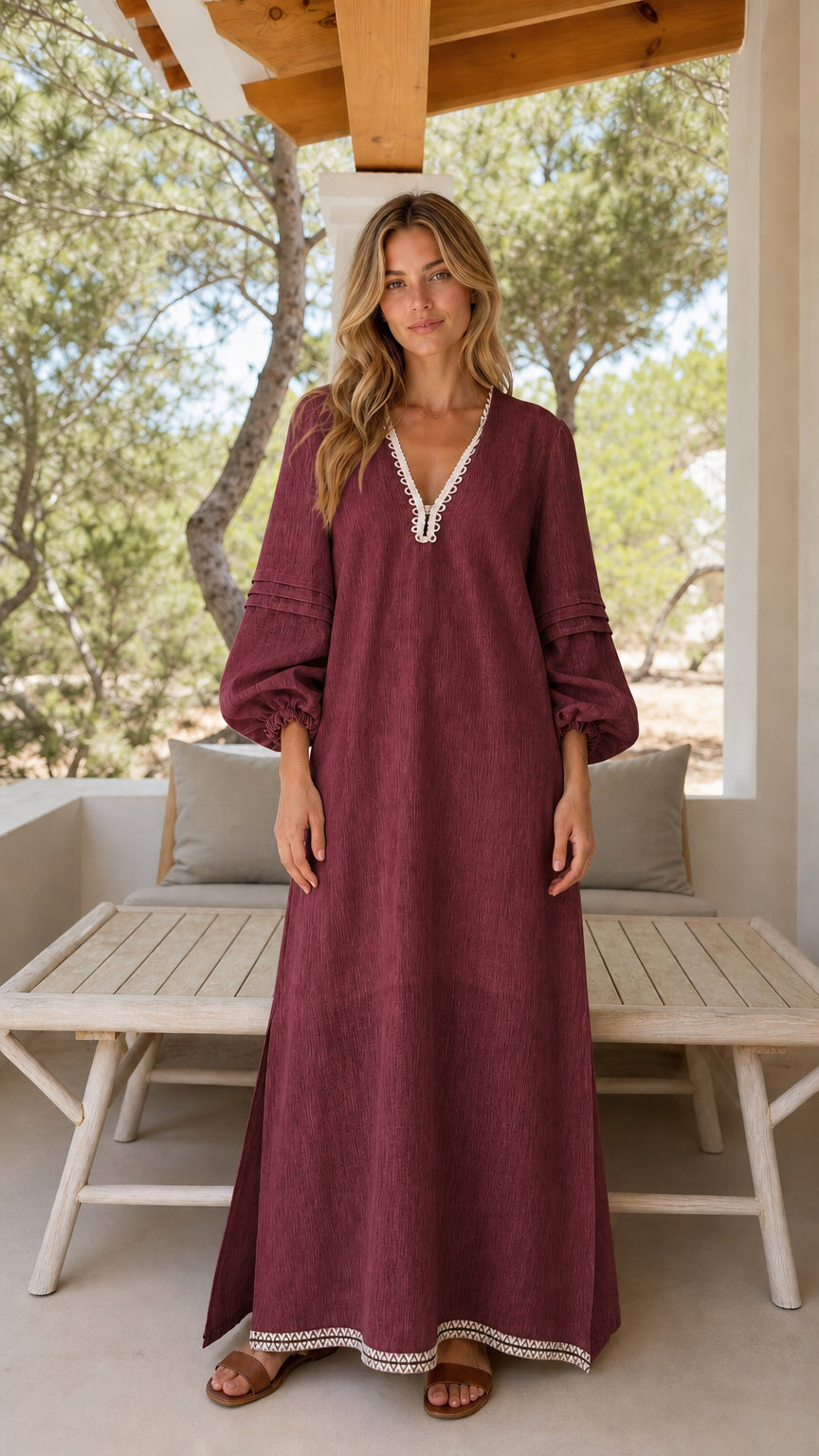 Front view of woman wearing burgundy long sleeve maxi dress