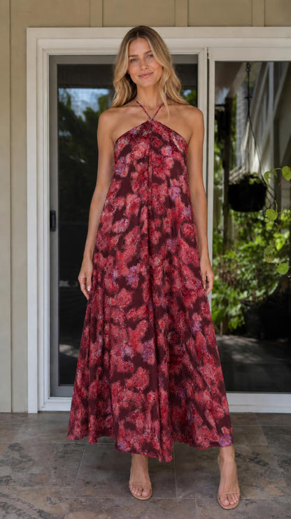 Model wearing burgundy floral print halter maxi dress