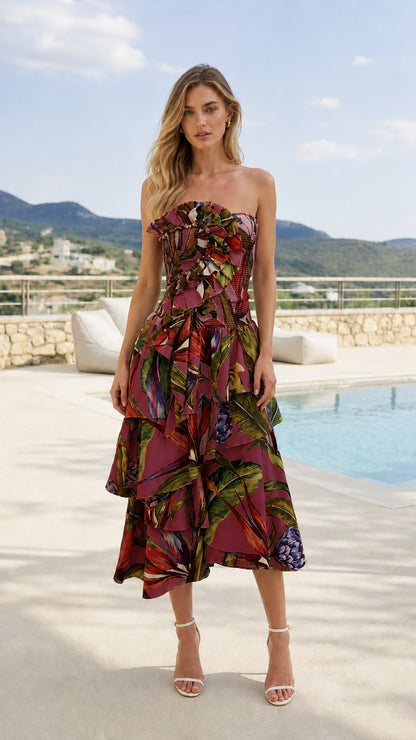 Front view of model wearing burgundy tropical print strapless midi dress