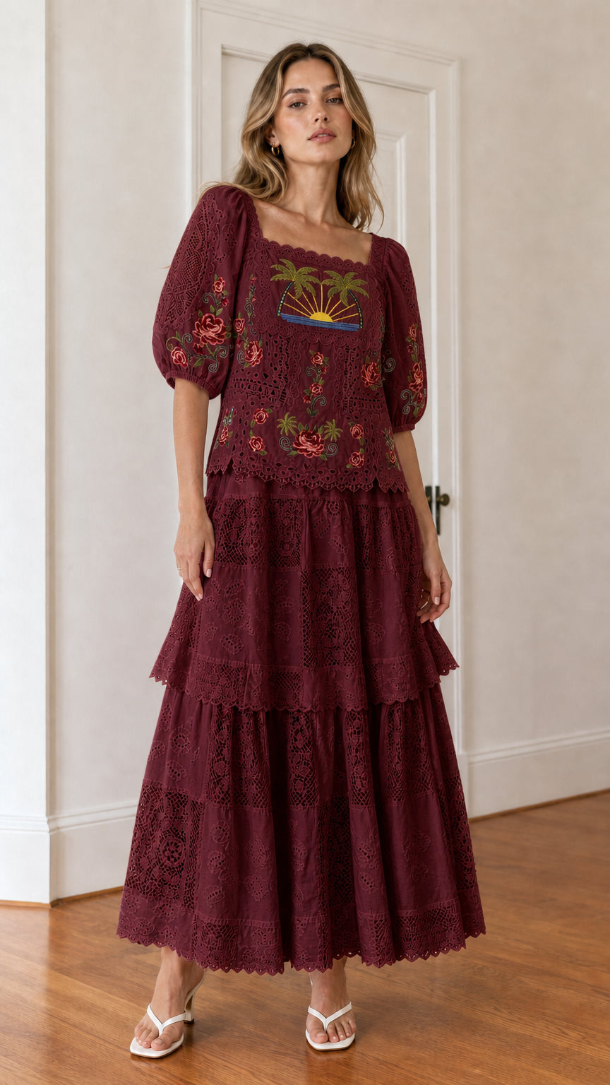 Front view of woman wearing burgundy embroidered maxi dress